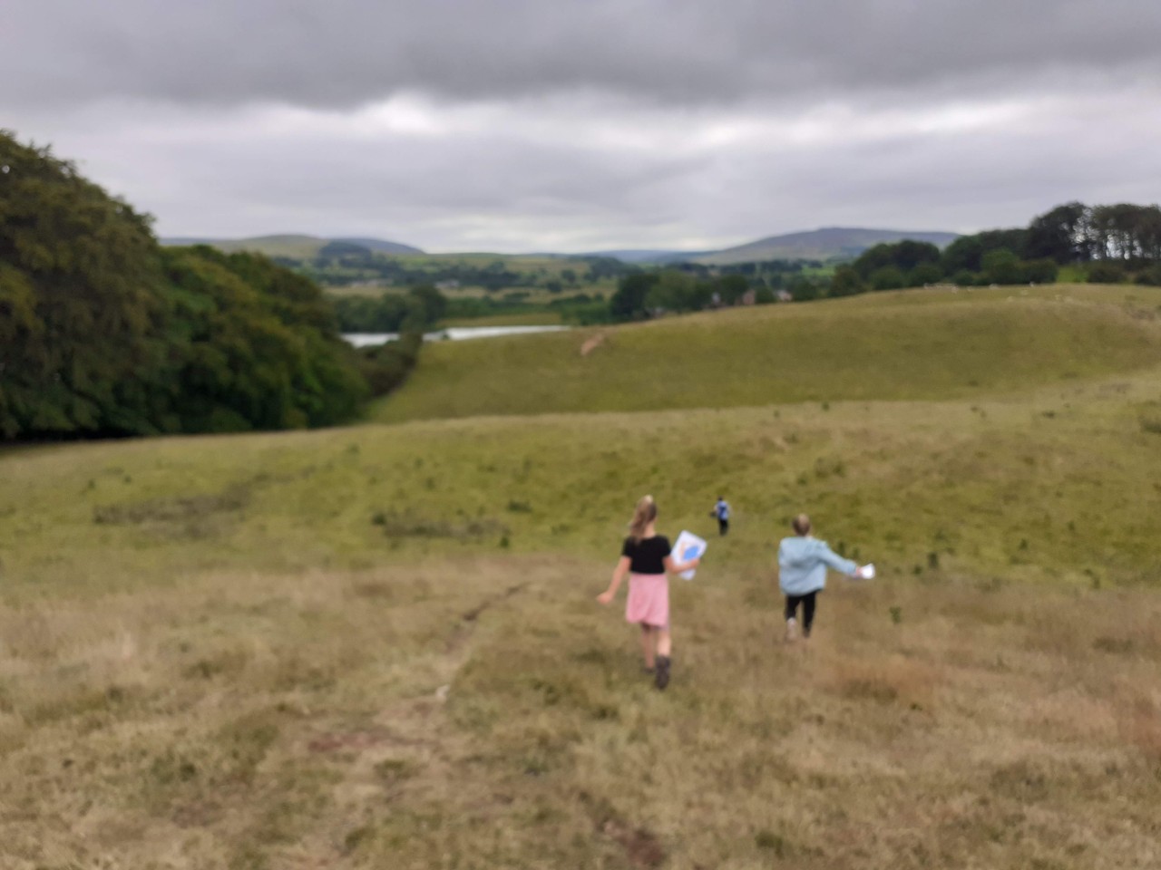Students orienteering in the field at Talkin Tarn